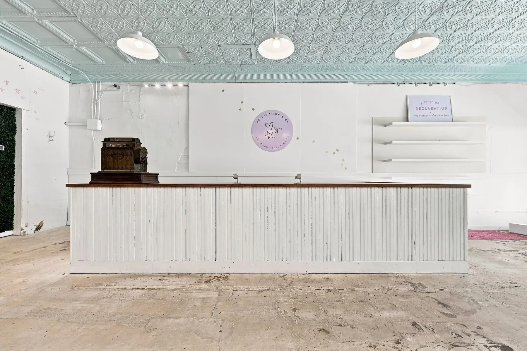 Built-in cash wrap and checkout counter beneath the original pressed tin ceiling