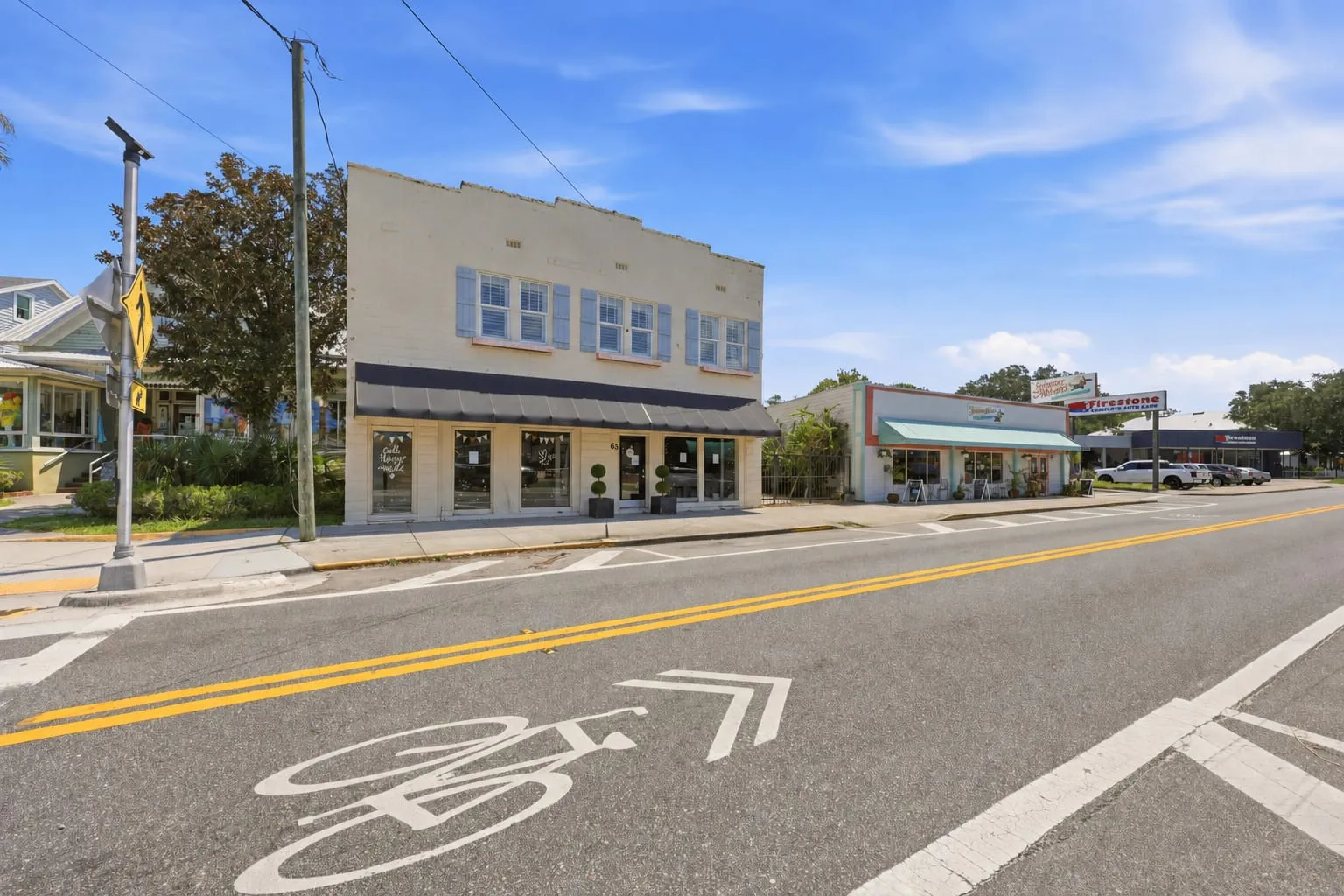 63 San Marco Avenue in context along the corridor, with neighbouring retail either side
