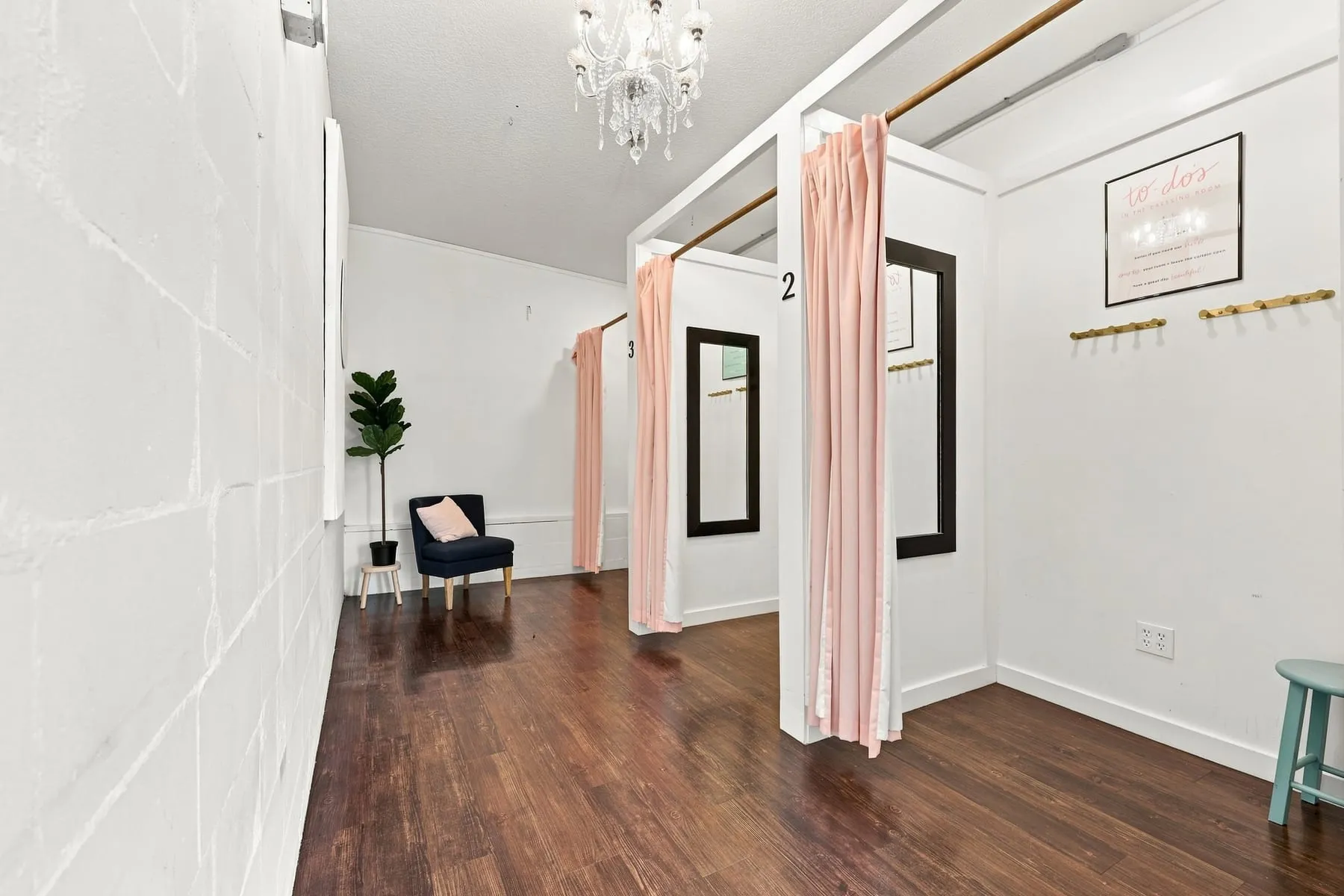 Fitting room bank with curtained entries and hardwood floor