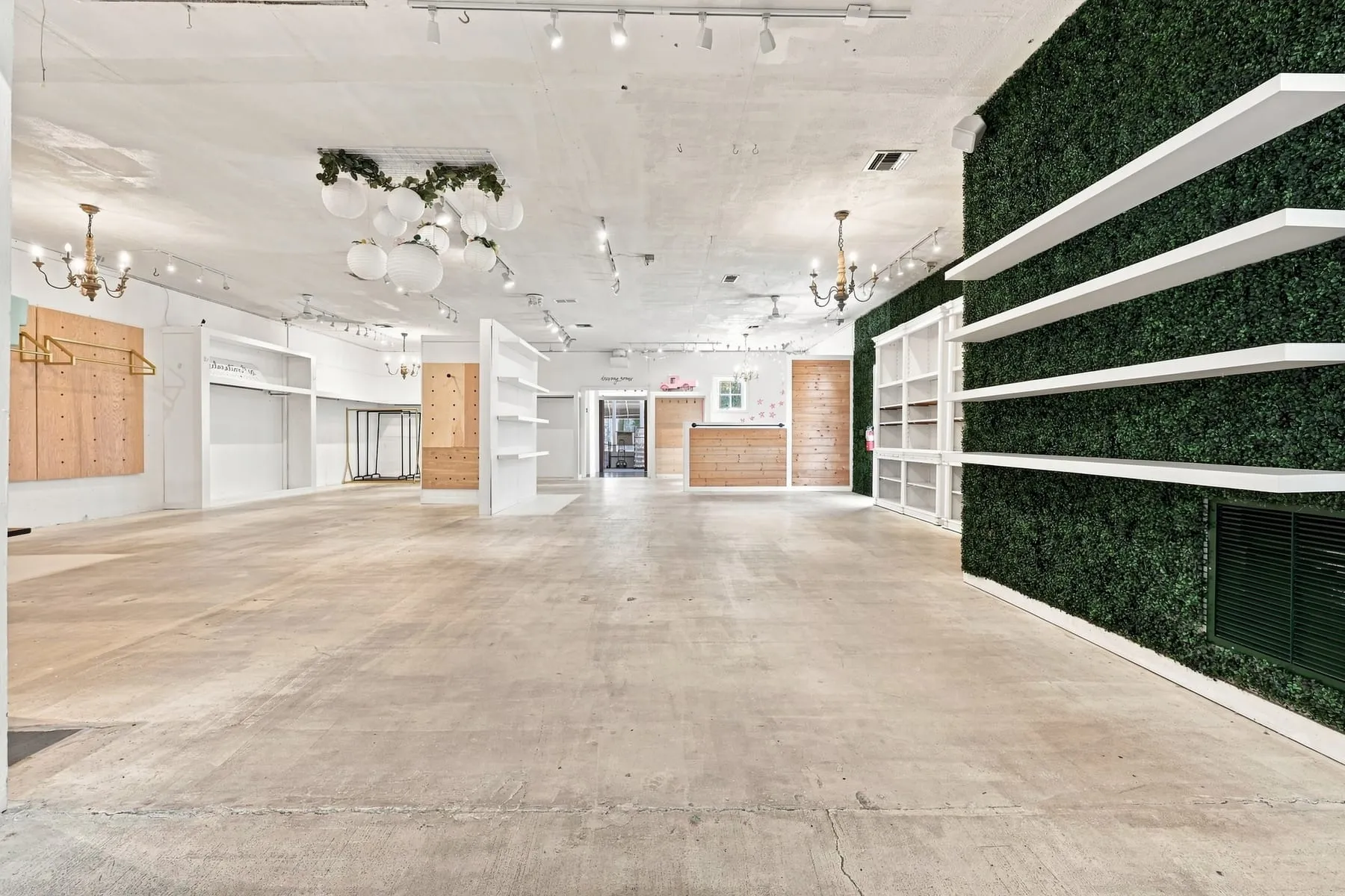 Wide view down the full depth of the main retail floor with built-in shelving