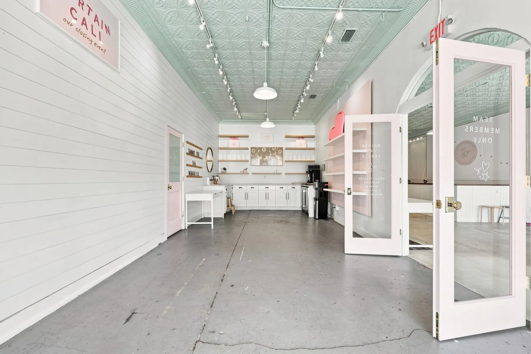 Retail area beneath the original pressed tin ceiling painted pale green