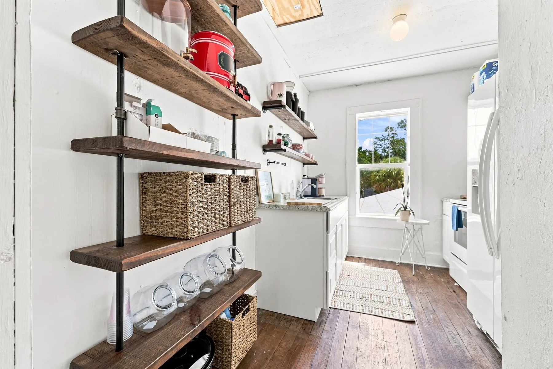 Second floor kitchen with counter, shelving and window
