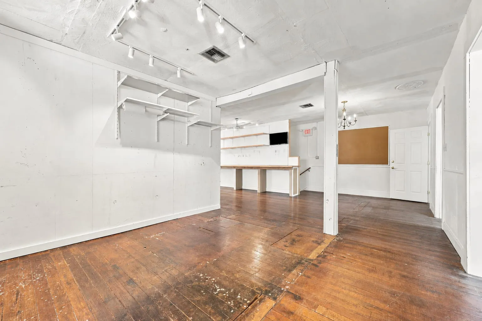 Second floor open room with original hardwood floors