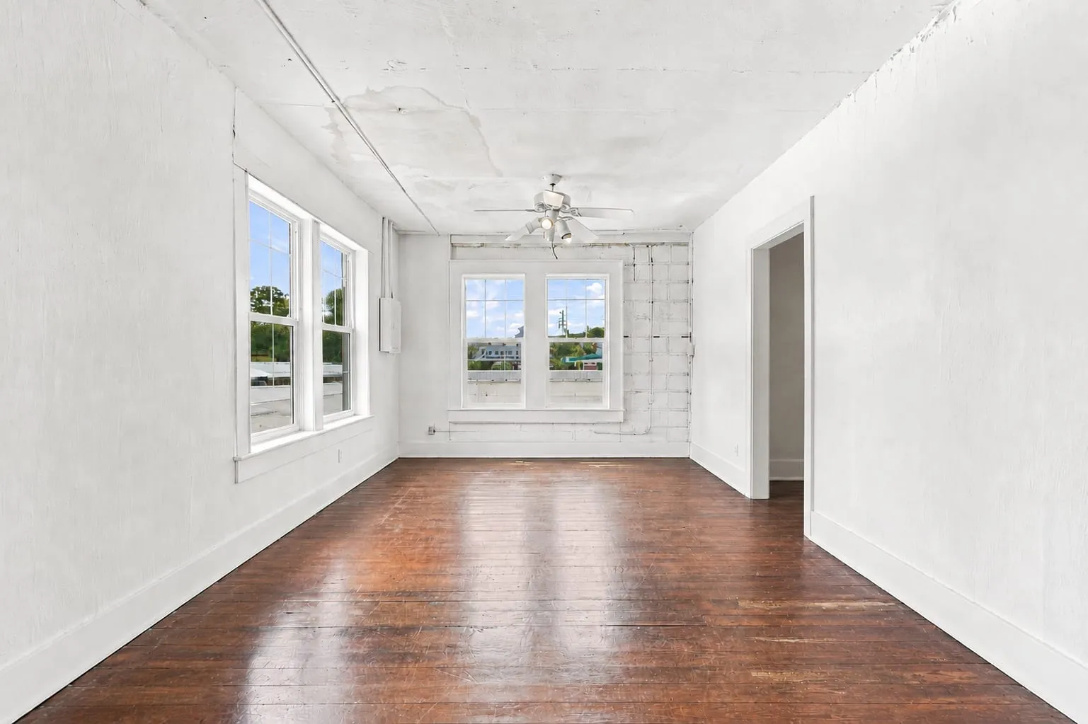 Second floor rear room with hardwood floors and windows to the rear