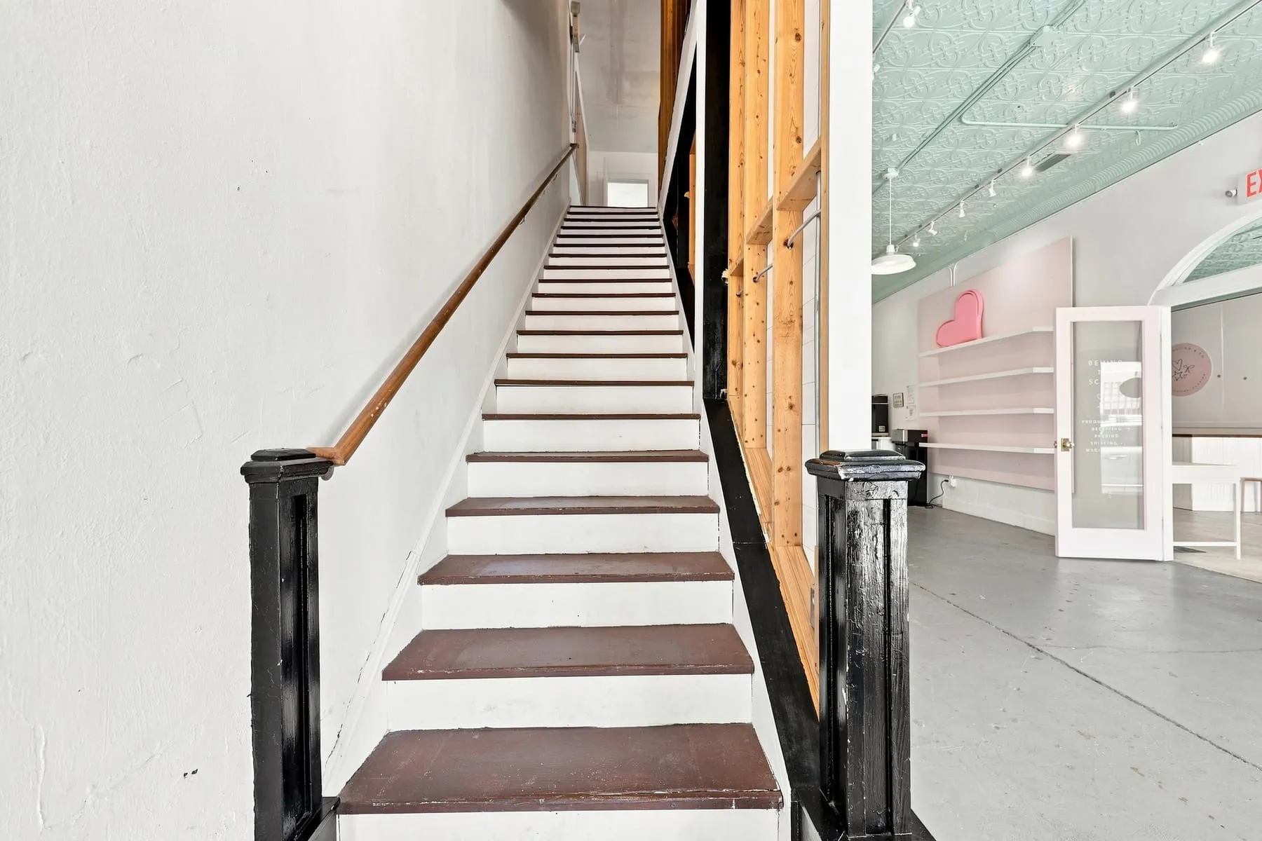 Staircase to the second floor with dark treads and white risers